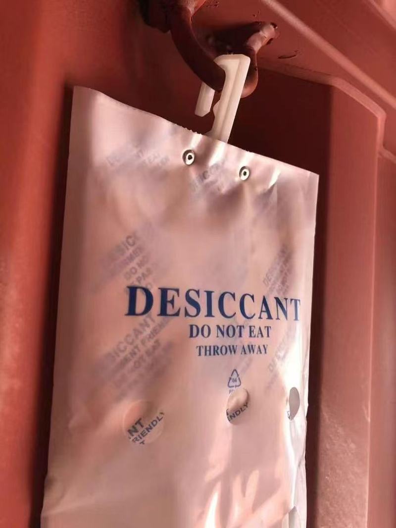 Container desiccant bag hooked onto the security ring inside an empty shipping container